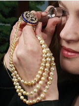 Susan Rumfitt examining Victorian pearl necklace c. 1860